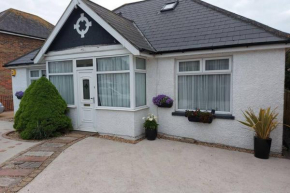 Bungalow with large rear garden, close to beach.